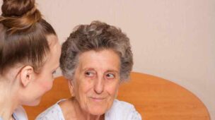 Cuidadora conversando com idosa que cuida em clima de harmonia